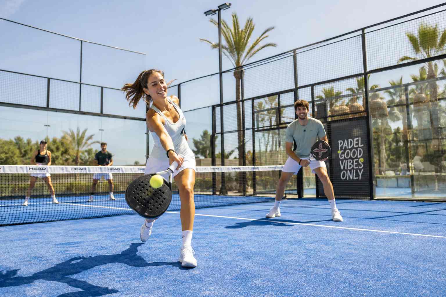 A padel player playing a shot